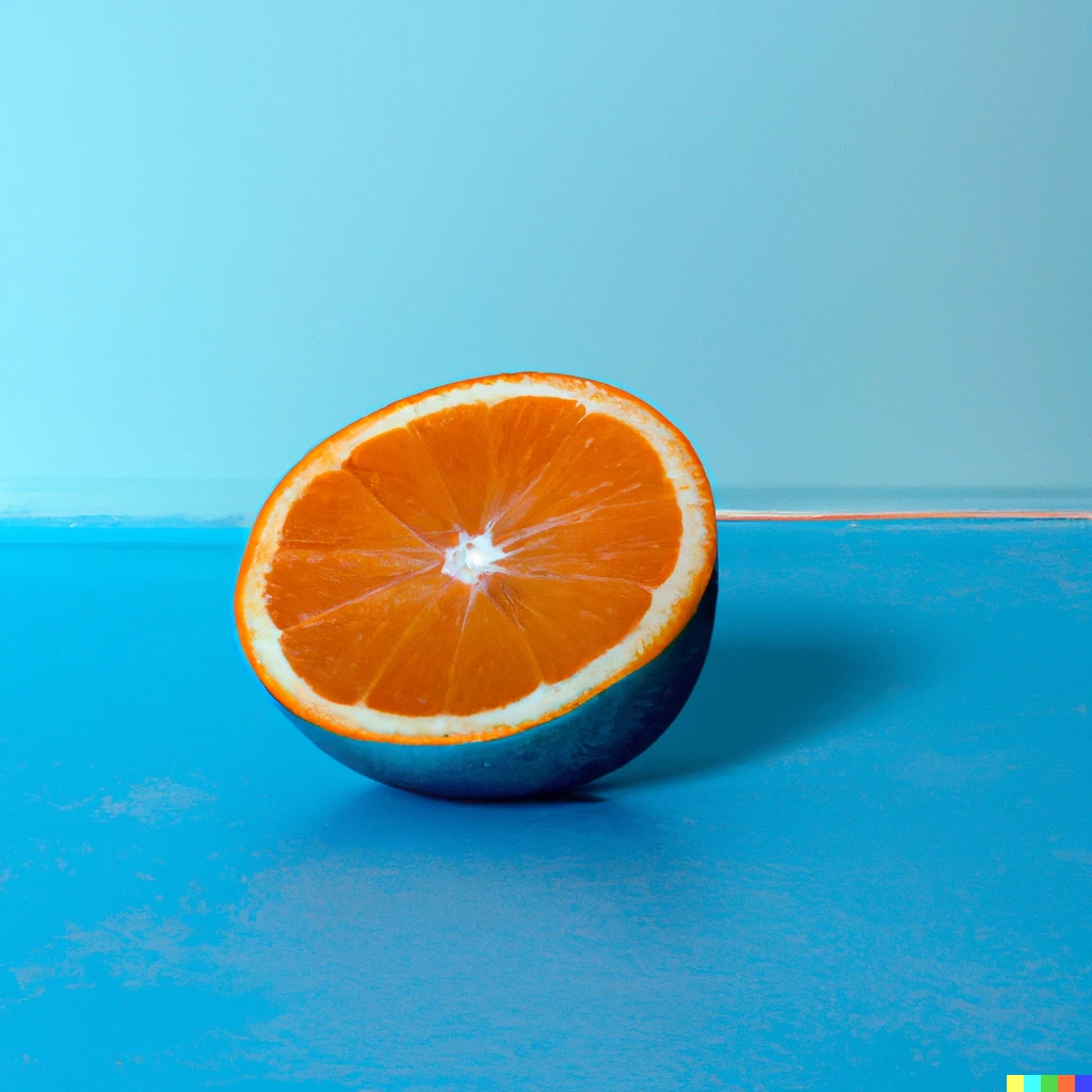 A blue orange sliced in half laying on a blue floor in front of a blue wall